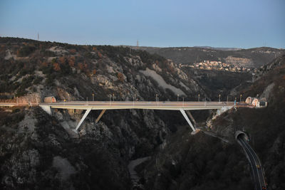 Aerial view of dam and mountains against clear sky