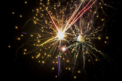 Low angle view of firework display at night