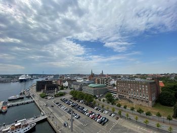 High angle view of townscape by sea against sky