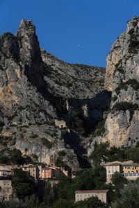 Houses on mountain against clear sky