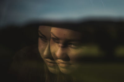 Close-up portrait of young woman looking away