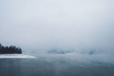 Scenic view of lake against sky during winter