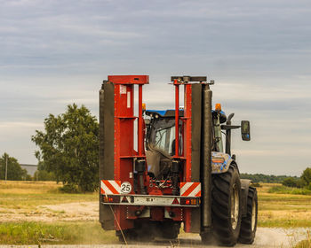 Tractor on field against sky