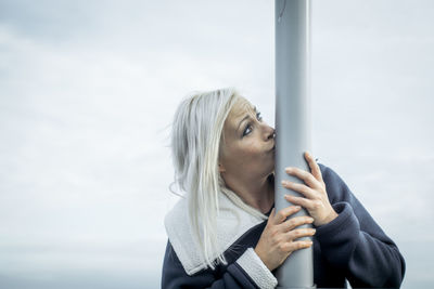Close-up of woman standing against sky