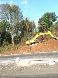 Construction site by road against sky