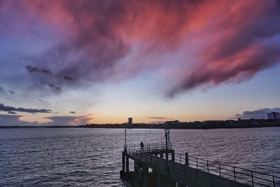 Scenic view of dramatic sky over sea during sunset