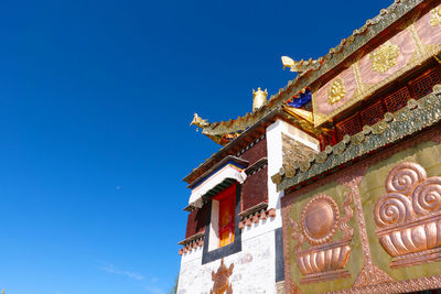 Low angle view of temple against clear blue sky