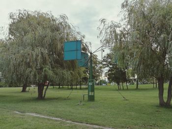 Trees on field against sky