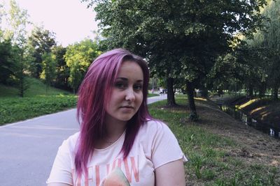 Portrait of beautiful woman against trees and plants