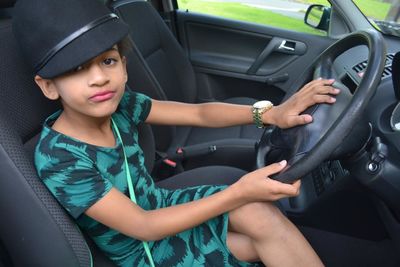 View of girl sitting in car