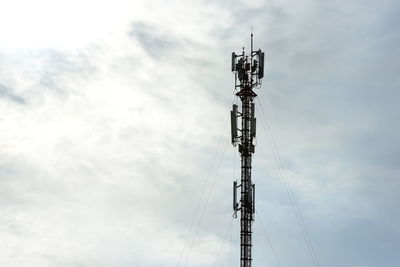 Low angle view of communications tower against sky