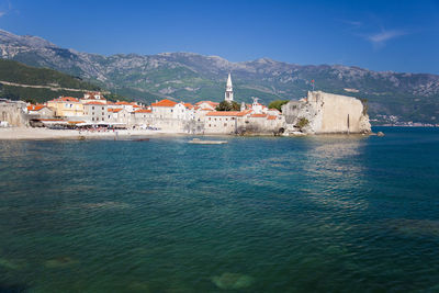 Scenic view of sea and buildings against sky