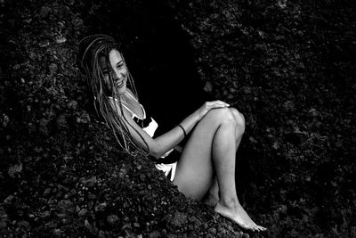 Young woman sitting on field