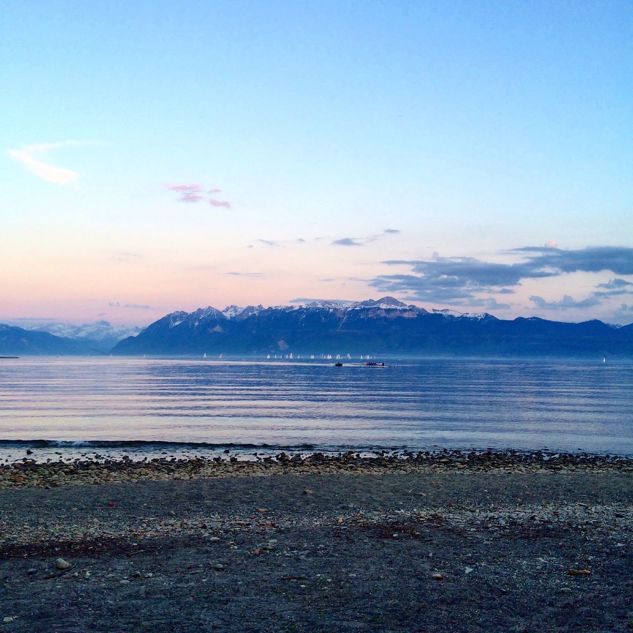 water, tranquil scene, scenics, sea, tranquility, mountain, sky, beauty in nature, beach, nature, idyllic, mountain range, shore, blue, cloud - sky, calm, sunset, sand, cloud, outdoors