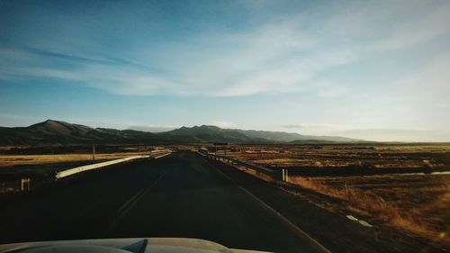 Country road leading towards mountains