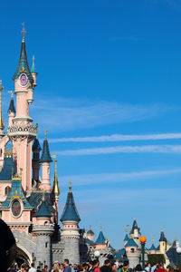 Low angle view of buildings against blue sky