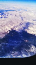 Low angle view of airplane wing over landscape