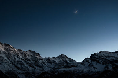 Scenic view of mountains against clear blue sky