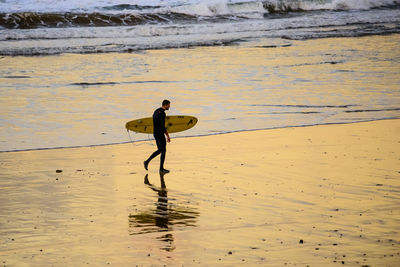 Full length of man walking on beach