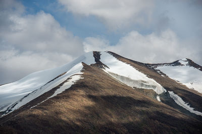 Low angle view of snow on mountain against sky