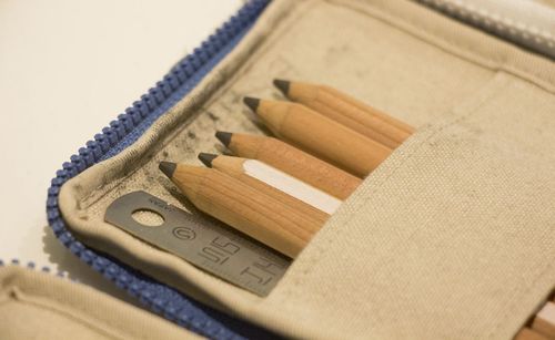 Close-up of pencils and ruler in pouch on table