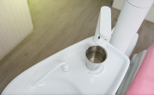 High angle view of equipment with glass of water on table