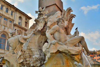 Low angle view of statue against historic building