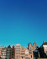 Low angle view of buildings against blue sky