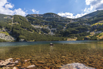 Scenic view of lake and mountains against sky