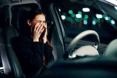 Woman crying while sitting in car