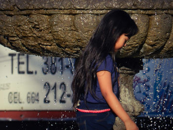 Full length of woman standing in water