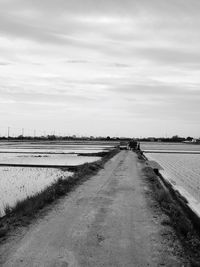 Road by landscape against sky