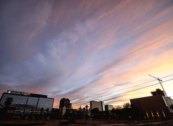 Low angle view of silhouette buildings against dramatic sky