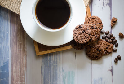 High angle view of coffee and cookies on table