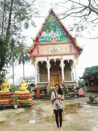 Full length of woman standing outside temple