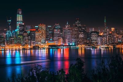 Illuminated buildings against sky at night