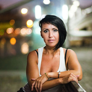 Portrait of young woman sitting outdoors