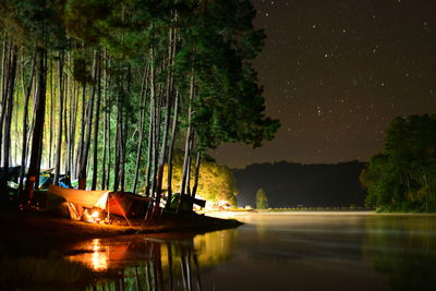 Scenic view of lake against sky at night