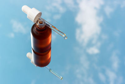 Low angle view of bottle against sky