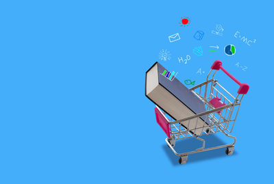 Close-up of shopping cart on blue background