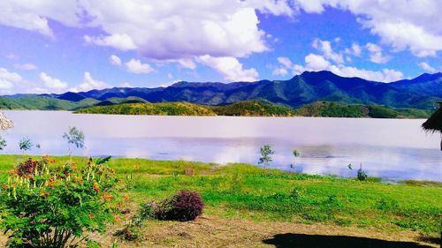 Scenic view of lake and mountains against sky