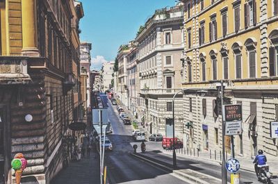 Panoramic view of city street and buildings against sky