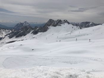 Scenic view of snow covered mountains against sky