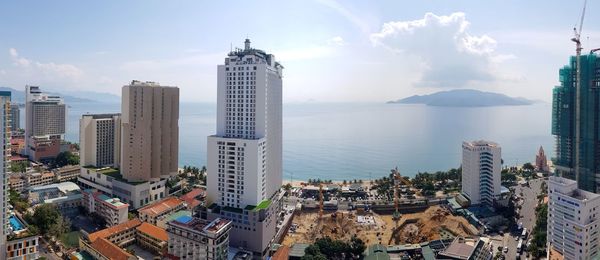 Panoramic view of sea and buildings against sky