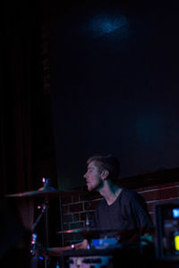 Young man looking at music concert