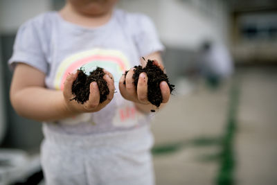 A little girl holds a garden plot