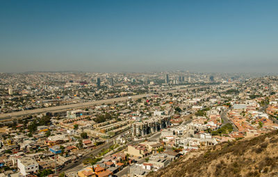 High angle view of buildings in city against clear sky