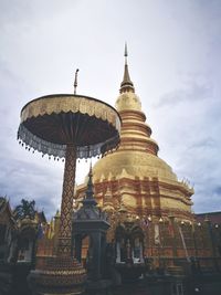 Low angle view of temple against clouds