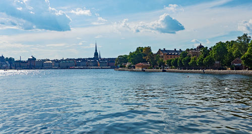 River amidst buildings against sky