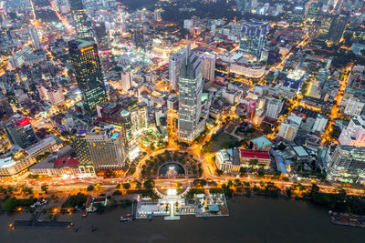 Illuminated cityscape against sky at night